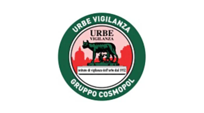 Logo circolare di Urbe Vigilanza con la Lupa capitolina al centro su sfondo rosso e bordo verde.